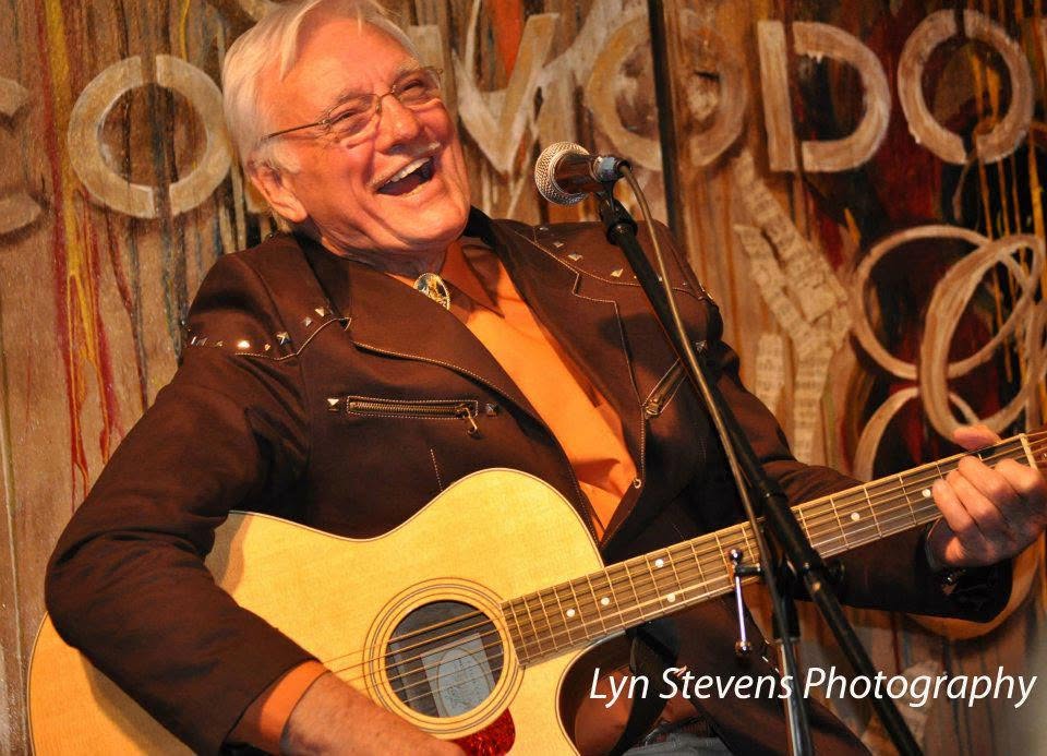 Jerry Foster laughing with his guitar at the Commodore Grille
