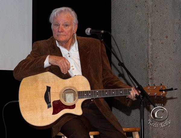 Jerry Foster seated with an acoustic guitar at the Country Music Hall of Fame