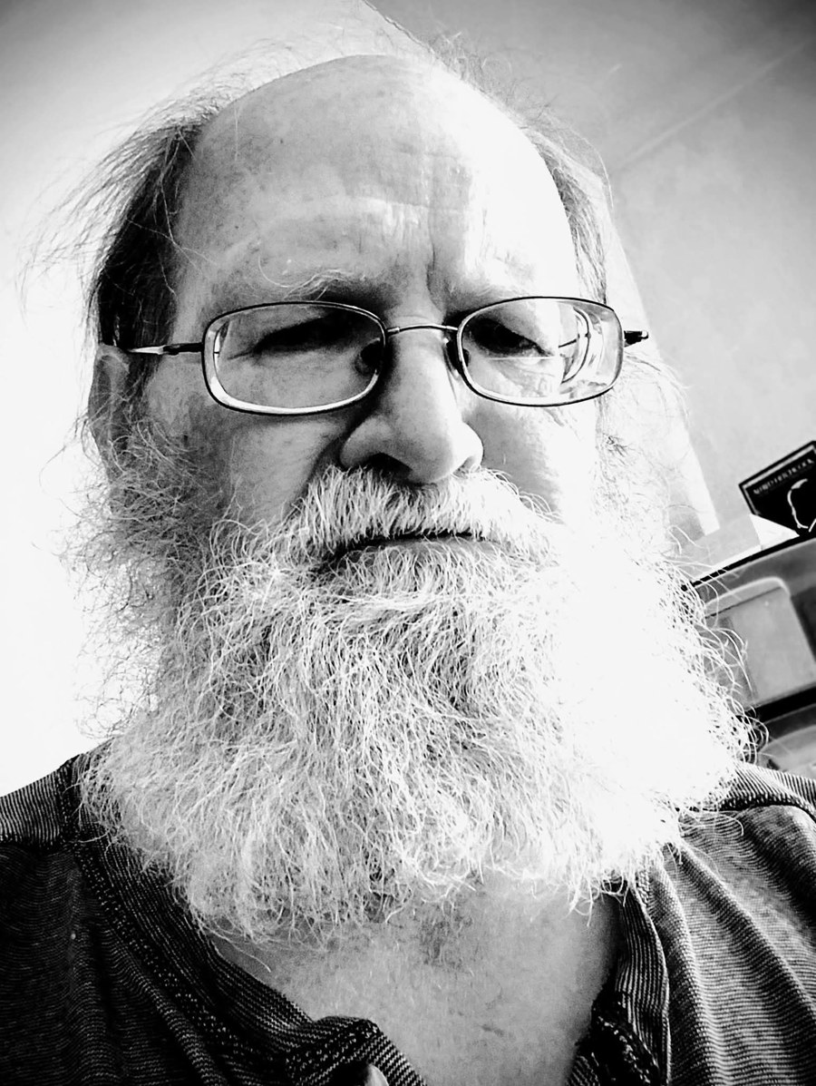 Black-and-white portrait of Doug McKim, with glasses and a long white beard