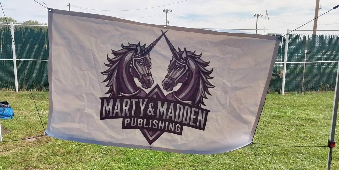 The Marty & Madden Publishing banner hung outdoors at a local event
