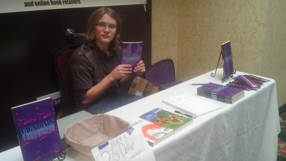 Robert Midgett at his signing table with stacks of Vagabonds